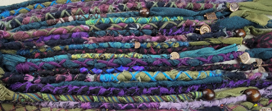 Handmade fabric dread wraps created from repurposed fabrics. Designed to complement locs, braid-ins, or temporary dread styles.