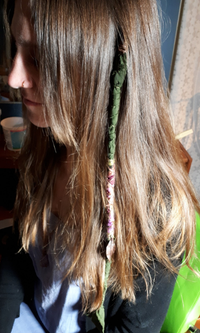 A fabric dread wrap braided into natural hair in Vancouver BC. A custom alternative or add-on to synthetic dreadlock extensions.