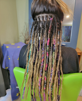 Fabric dread wraps combined with braid-in loc extensions for a natural, customizable loc look. Installed in Vancouver BC.